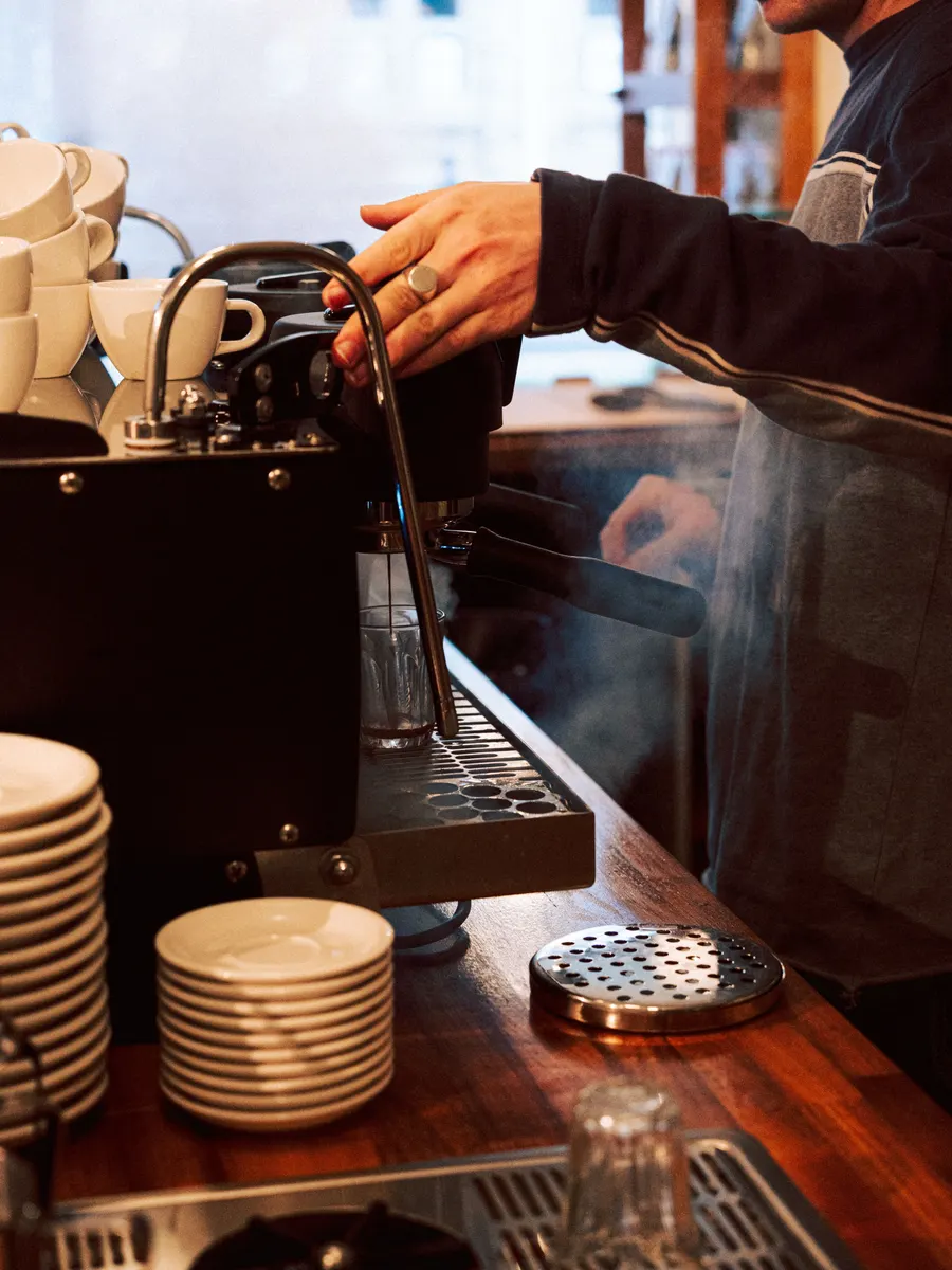 A barista at the espresso machine