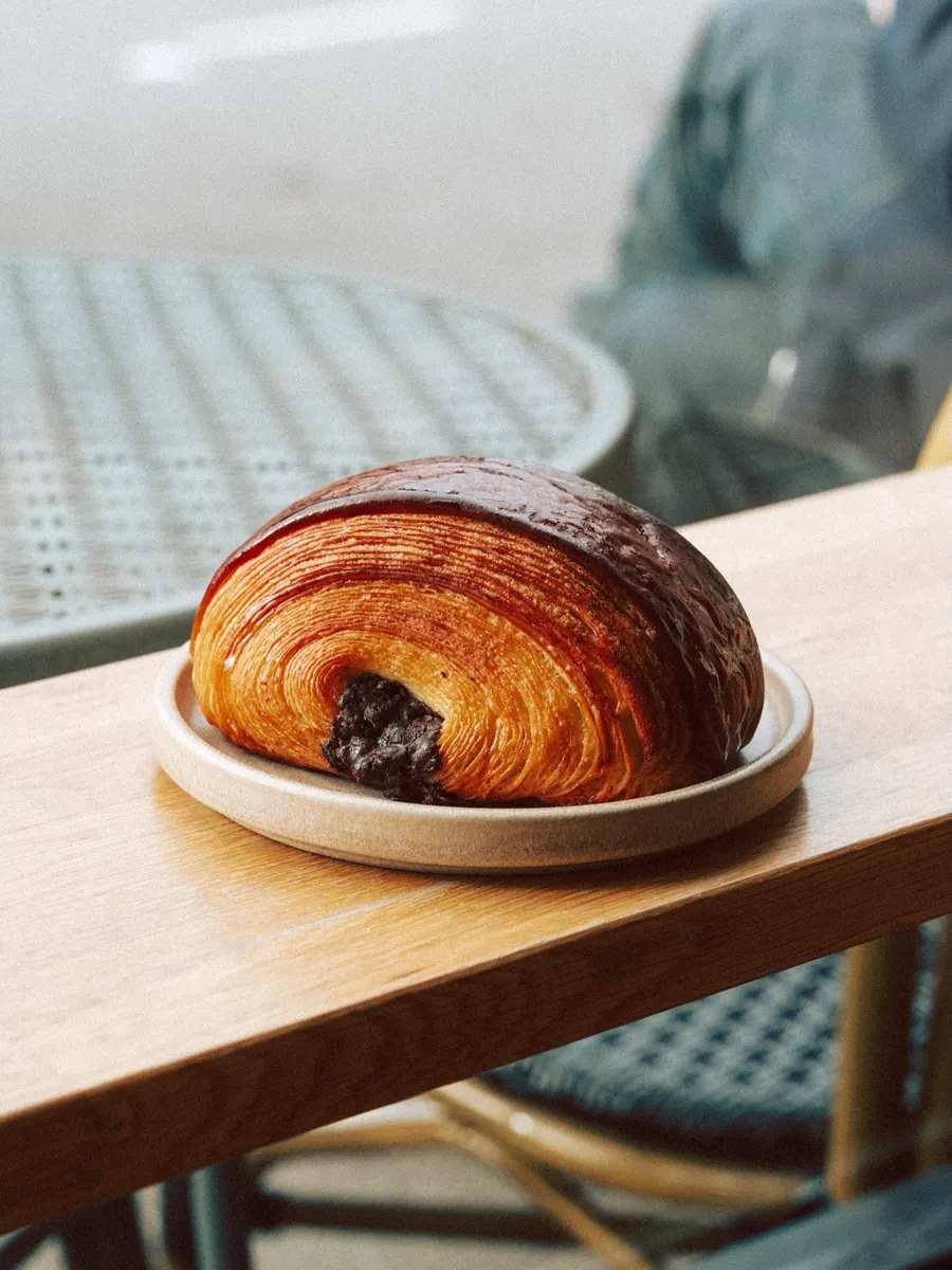 A croissant on a stoneware plate