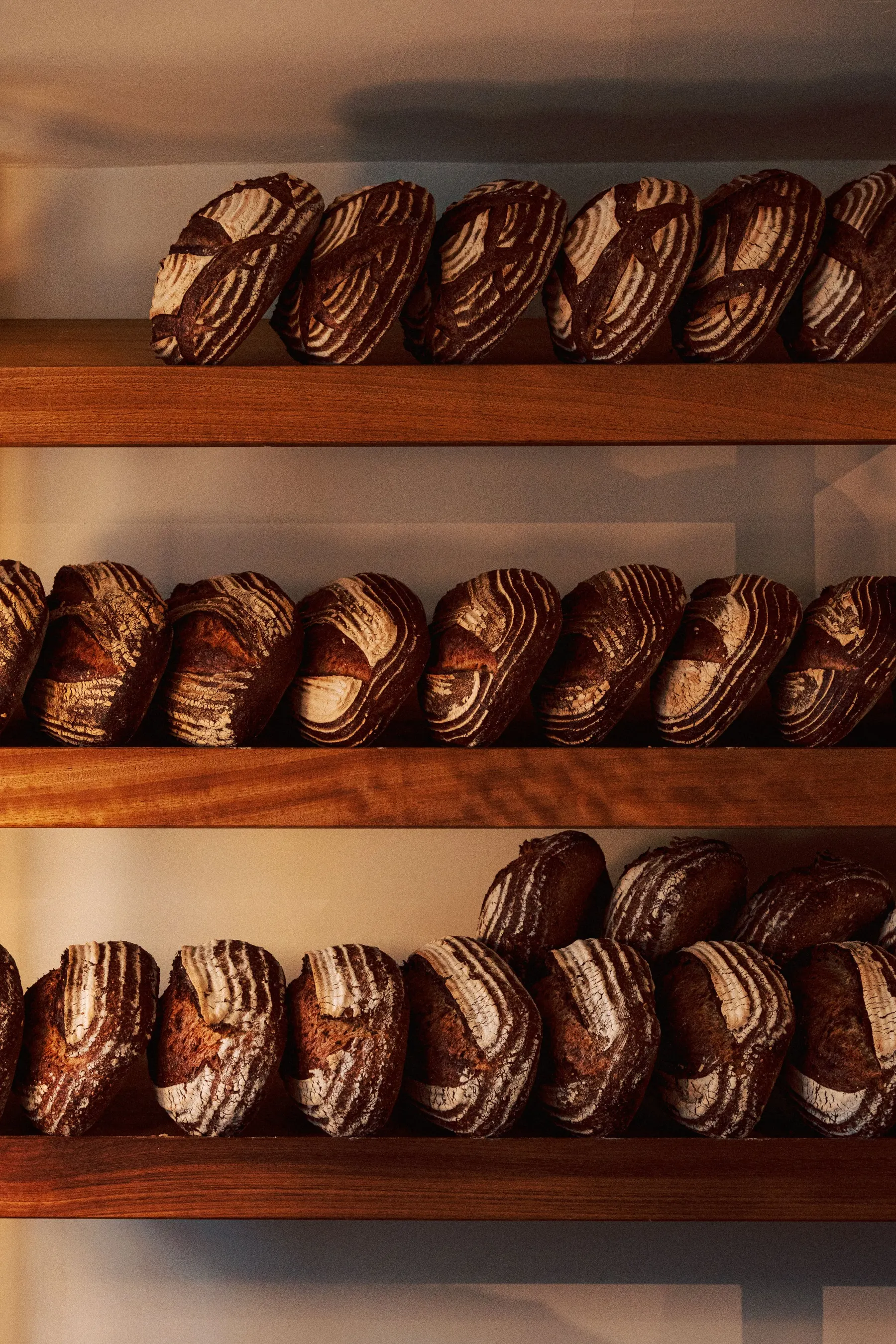 Laminated pastries cooling on wooden shelves