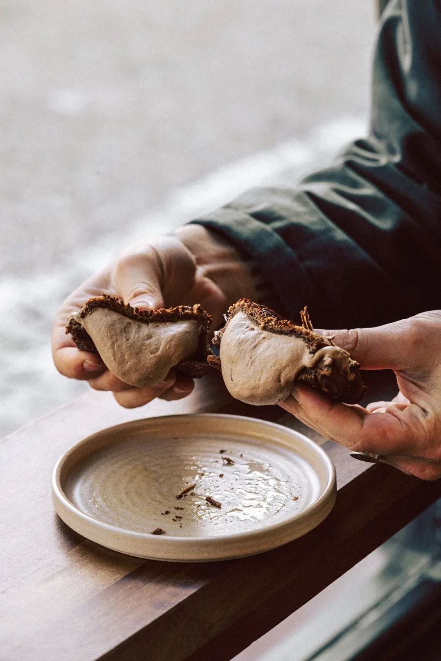 Hands tearing open a laminated pastry
