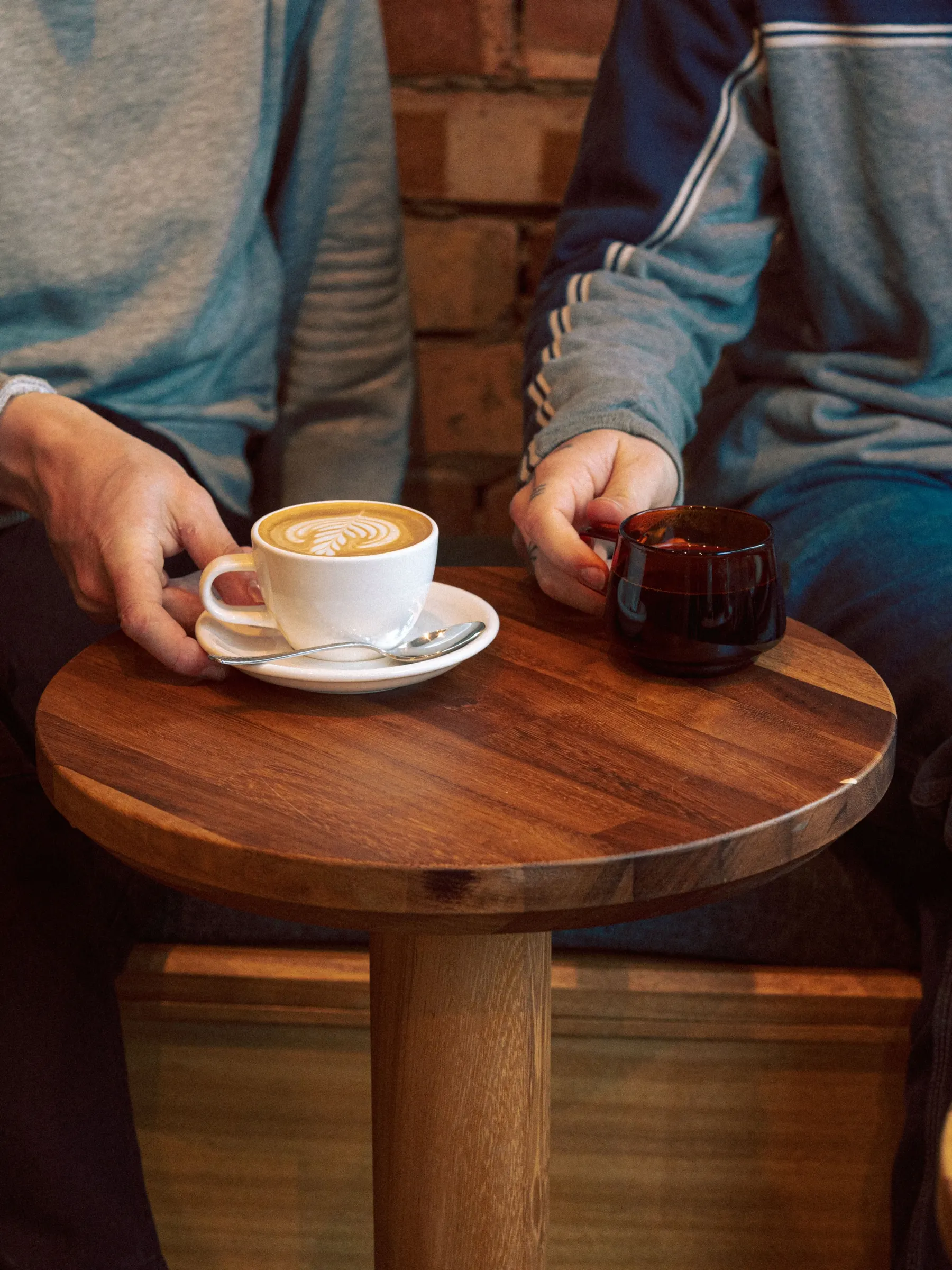 Two coffees on a round wooden table
